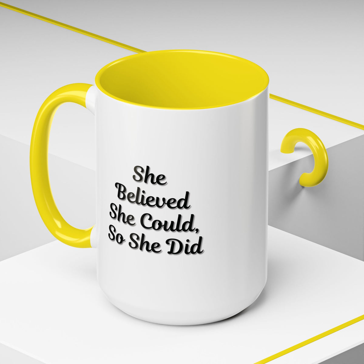 Motivational coffee mug with the quote "She Believed She Could, So She Did" in black text on a white ceramic mug.