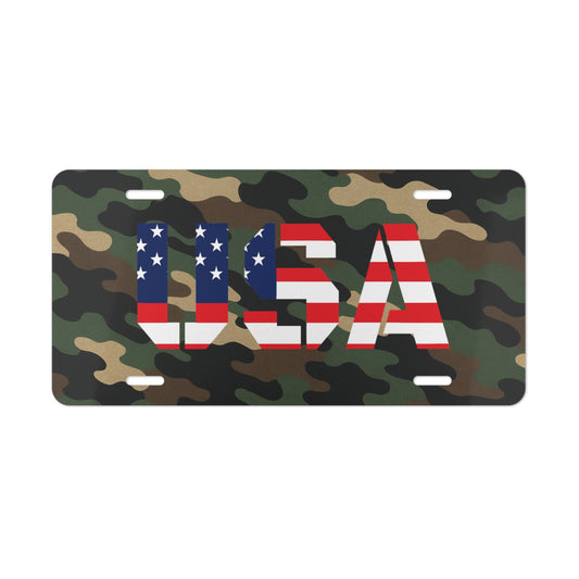 USA Camo vanity license plate with American flag-themed letters on camouflage background, accessory for vehicle customization.
