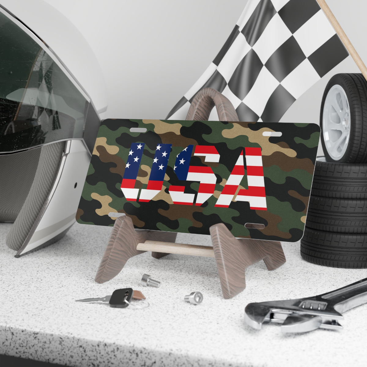 Camouflage USA vanity license plate with American flag-themed letters, designed as a patriotic accessory for vehicles.