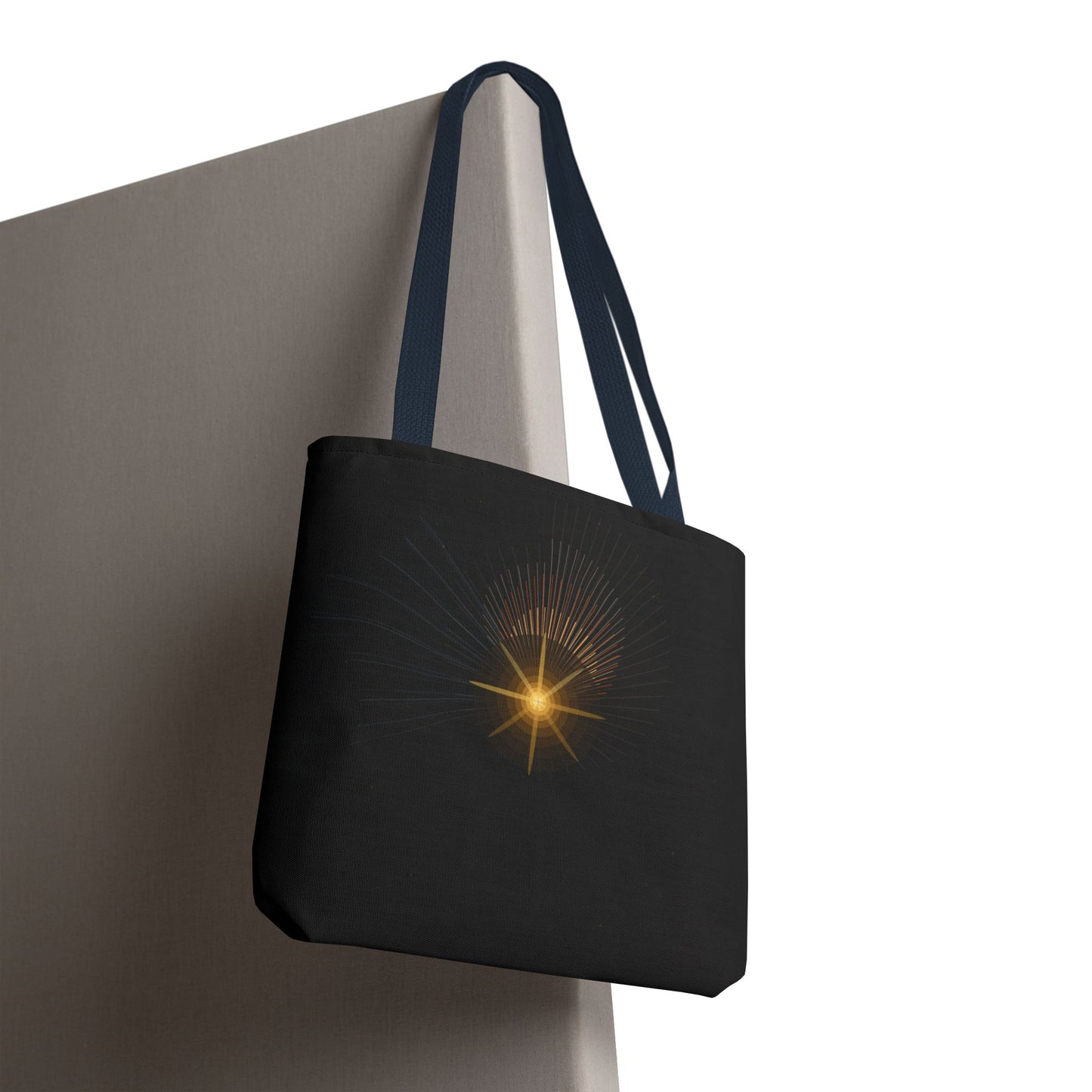 Golden celestial starburst tote bag with radiant design, stylish and spacious bag by Printify for everyday use.