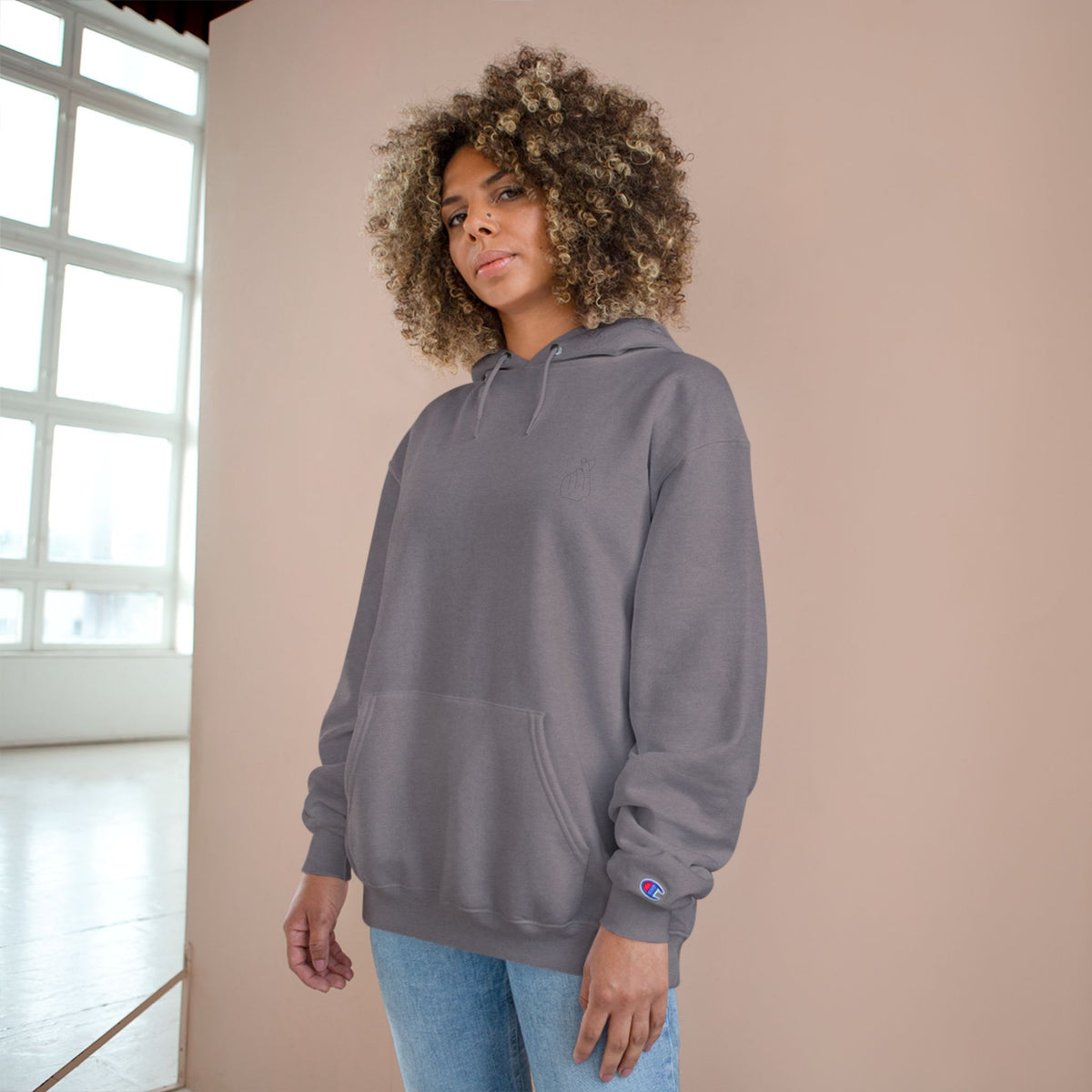 White Champion hoodie with Korean finger heart graphic, minimalist pullover style, branded by Printify.