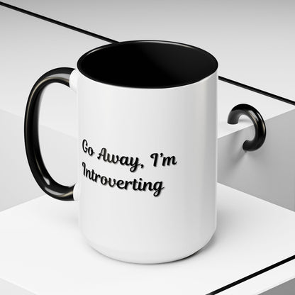 Ceramic introvert coffee mug with "Go Away, I'm Introverting" slogan, 11 oz size, featuring a white and black design.