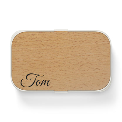 Personalized wooden bento lunch box with engraved name "Tom," accessories by Printify, showing a natural wooden finish and compact design.