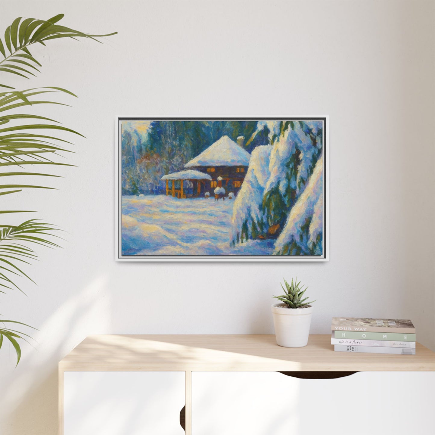Framed matte canvas print of a snowy winter cabin landscape, showcasing a cozy winter scene with trees and snow-covered ground.