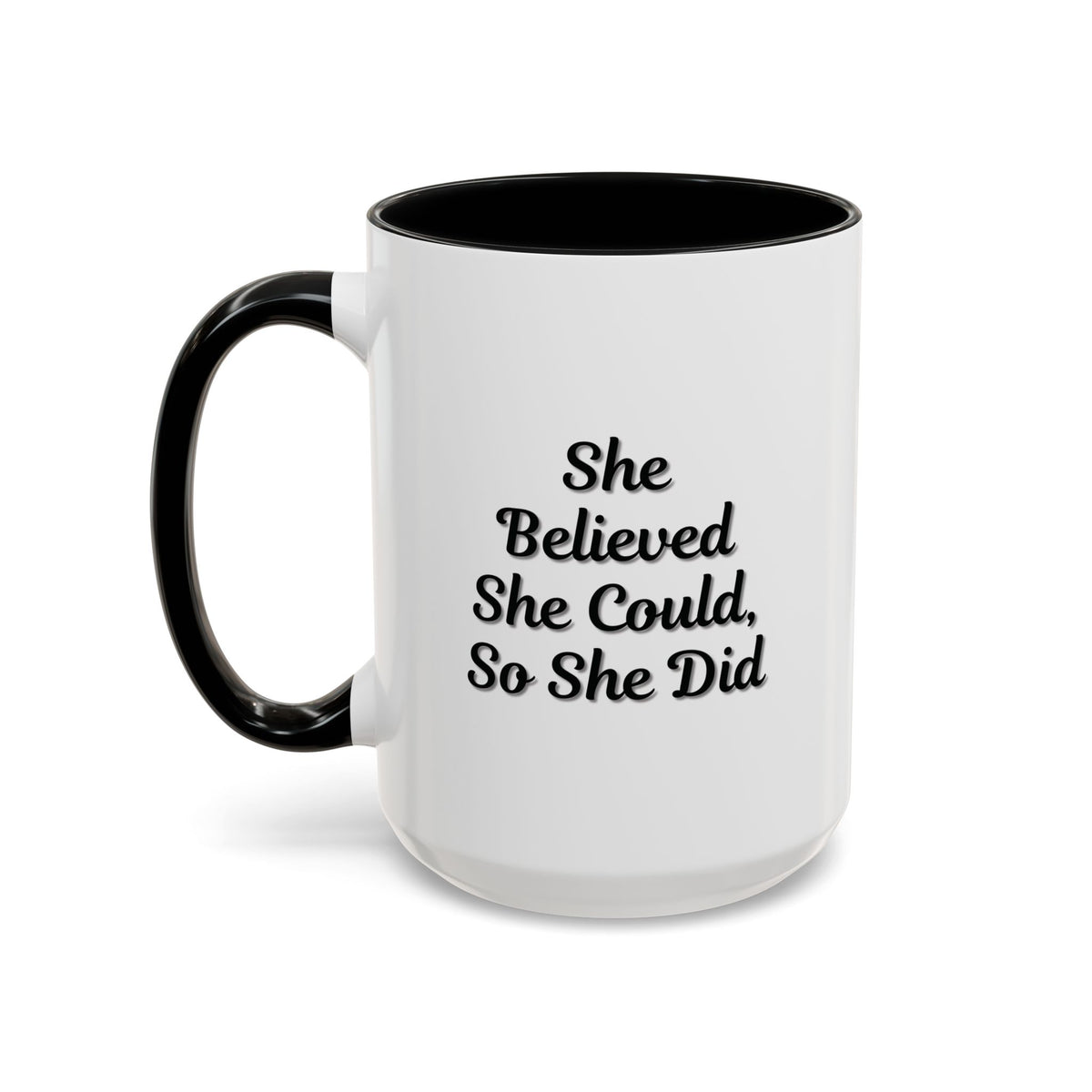White ceramic motivational coffee mug with black script reading "She Believed She Could, So She Did" on a plain background.
