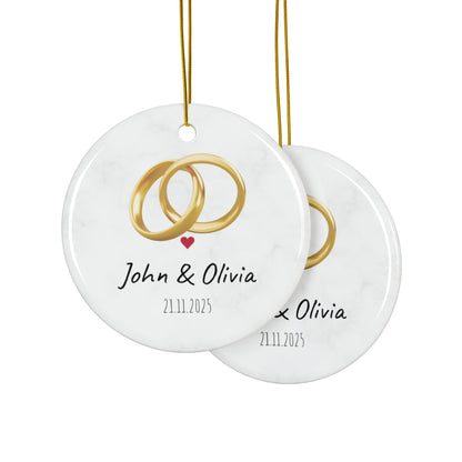 Round ceramic wedding rings ornament with personalized names and date, featuring elegant design for special occasion decor.
