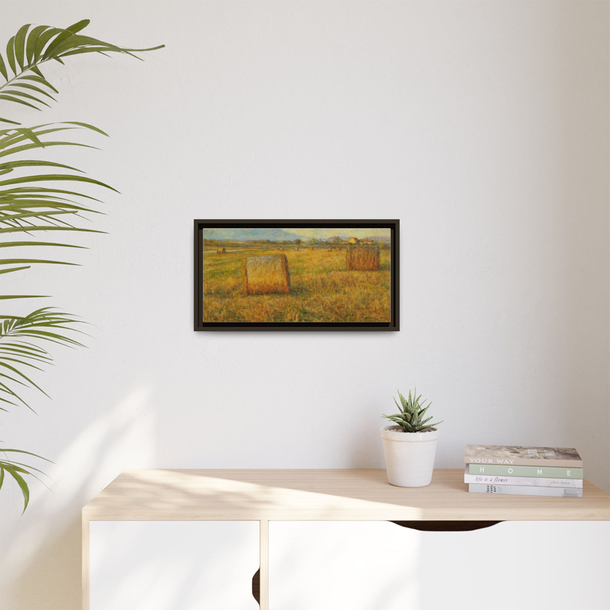 Framed matte canvas wall art featuring a rustic hayfield landscape print by Printify, showcasing vibrant colors and natural scenery.