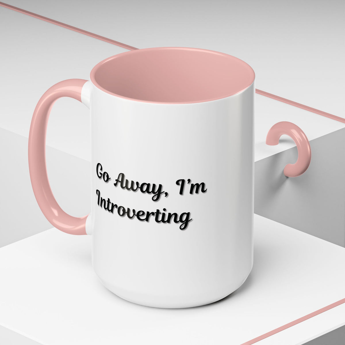 Ceramic introvert coffee mug with "Go Away, I'm Introverting" text in black, 11 oz size, suitable for hot beverages.