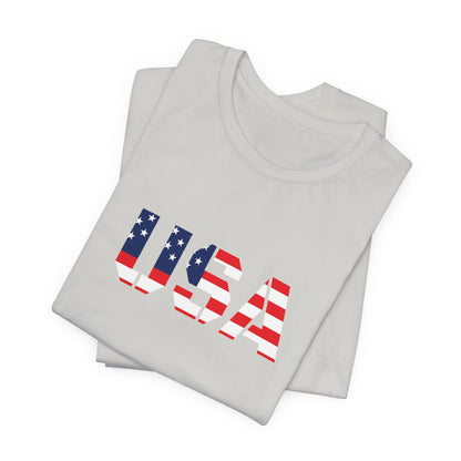 USA flag text T-shirt by Printify featuring patriotic red, white, and blue design, perfect for Fourth of July celebrations.
