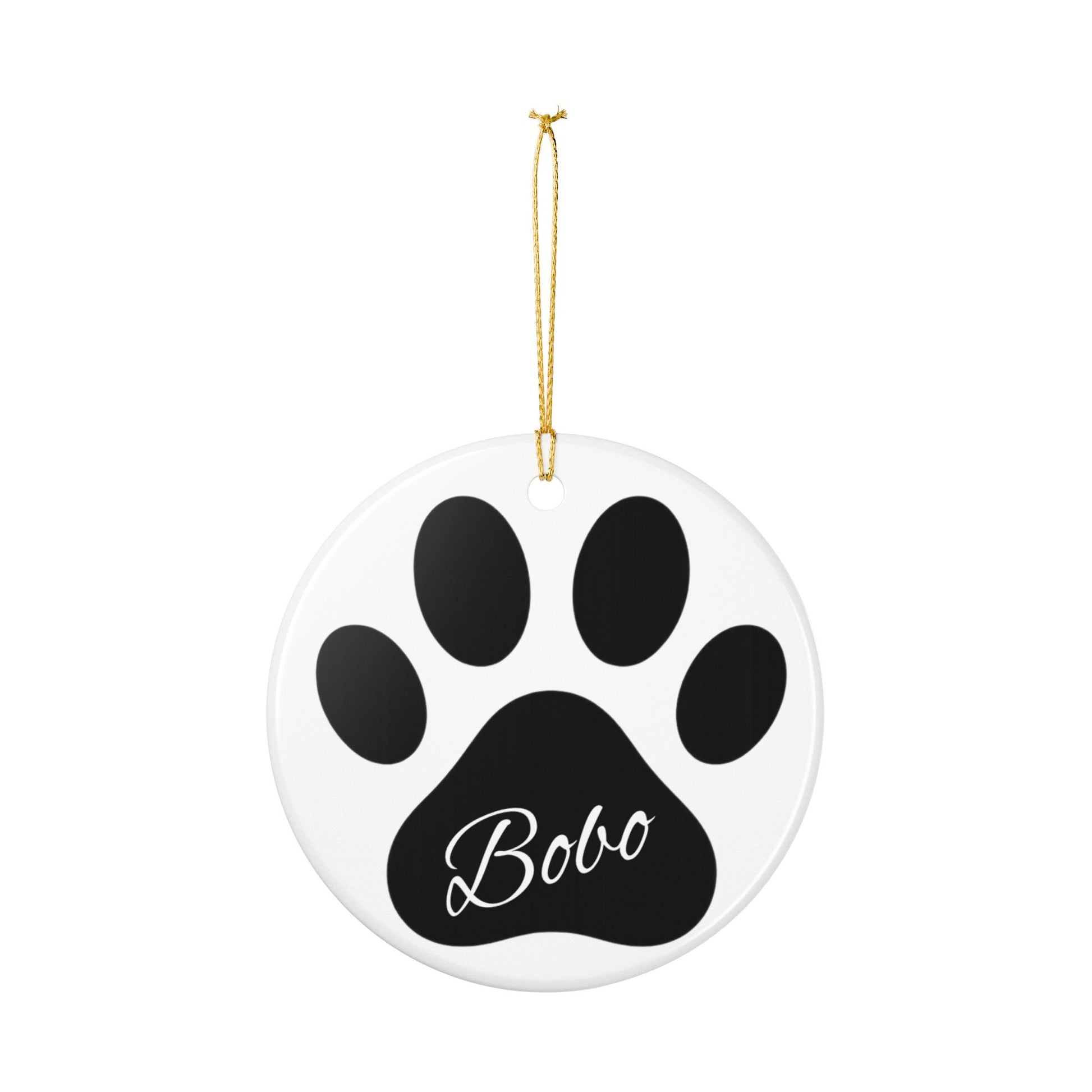Black paw print ceramic ornament with pet's name, ideal for memorial Christmas decoration, by Printify.