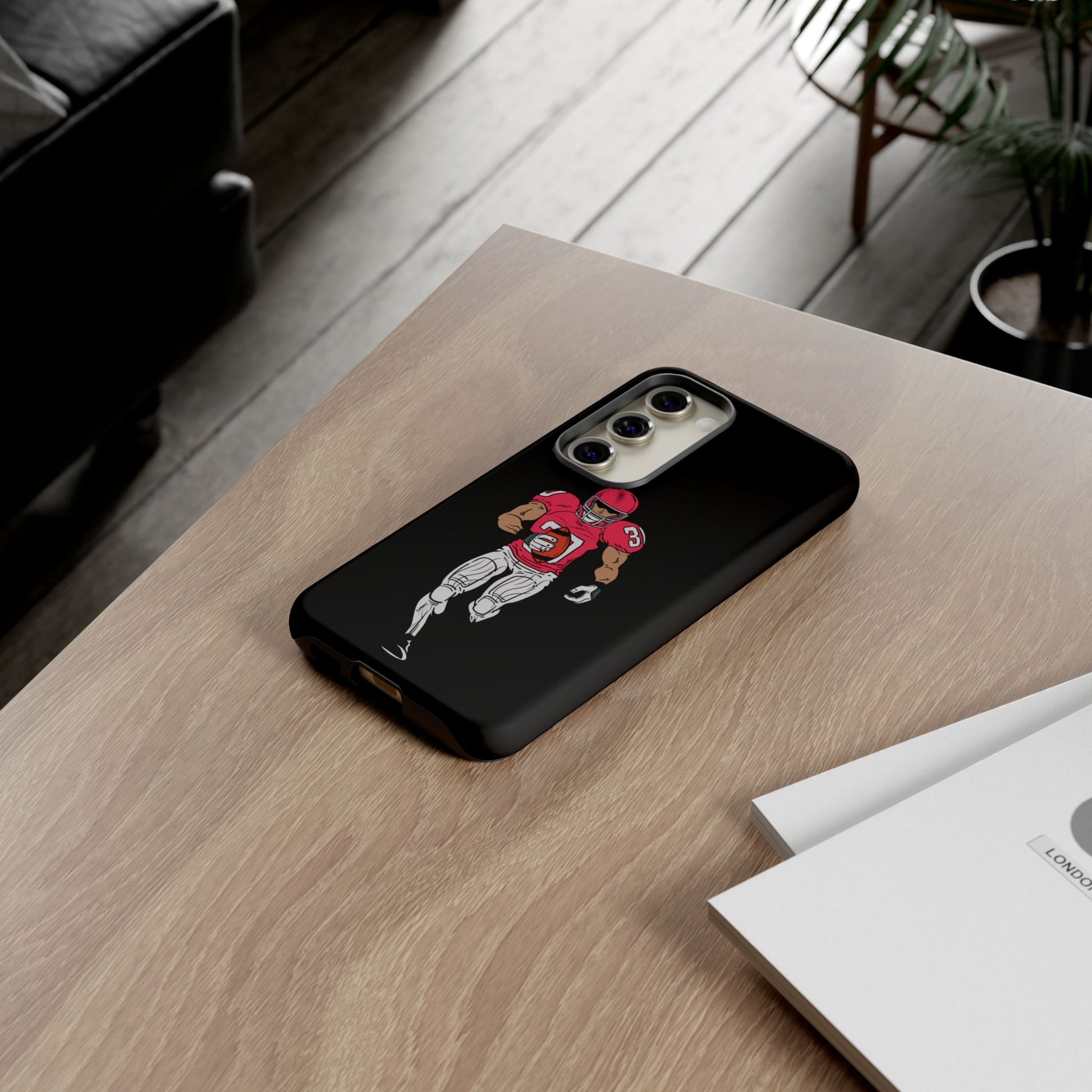 Black football player tough phone case for iPhone with sports design, offers durable protection and sporty style.