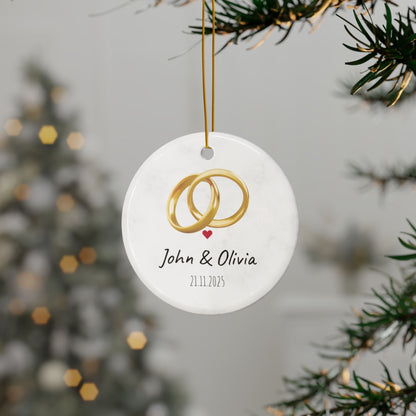 Round ceramic wedding ring ornament with personalized names and date, featuring elegant design and smooth finish.