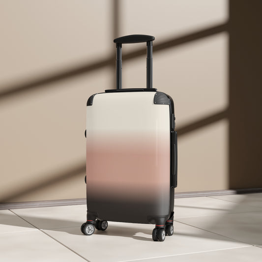 Gradient carry-on suitcase in blush to charcoal ombre design, featuring a portable travel bag with sturdy wheels and handle.