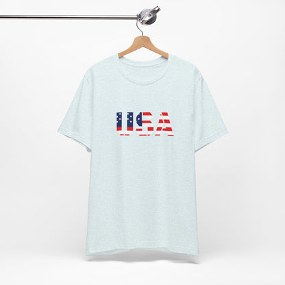 USA flag text T-shirt by Printify featuring patriotic Fourth of July design, casual cotton T-shirt with bold red, white, and blue flag graphic.