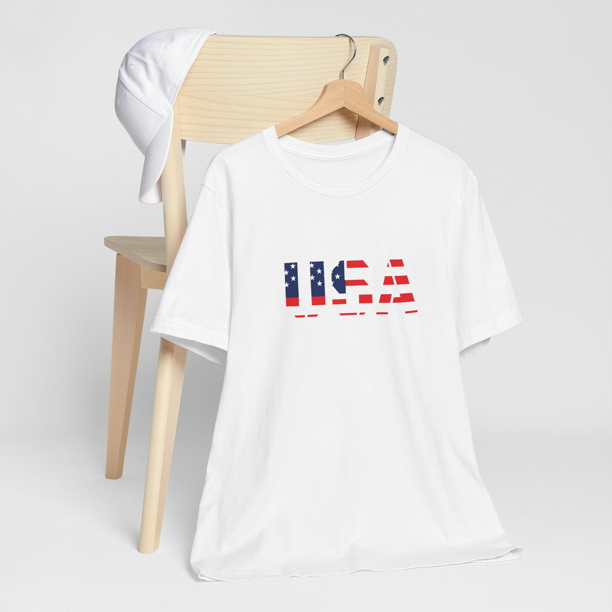 Red, white, and blue USA flag text patriotic T-shirt by Printify, featuring American flag design for Fourth of July celebrations.