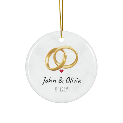Round ceramic wedding rings ornament with personalized names and date, ideal for wedding decor or keepsake.