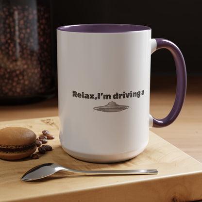 Ceramic coffee mug with "Relax, I’m Driving" UFO accent design, available in 11 oz or 15 oz sizes, by Printify.