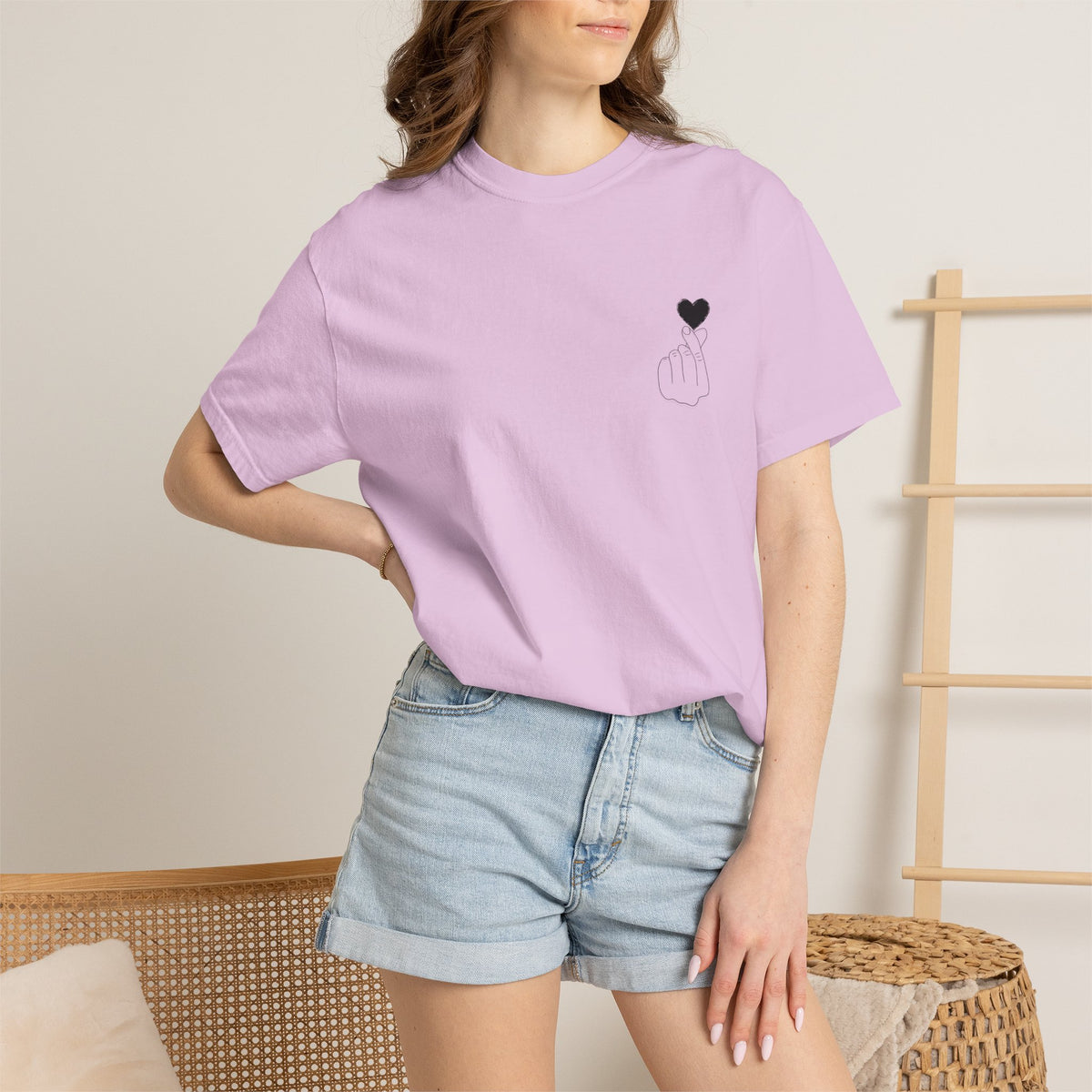 Black T-shirt with a minimalist white finger heart graphic, featuring the Printify brand logo on the front.