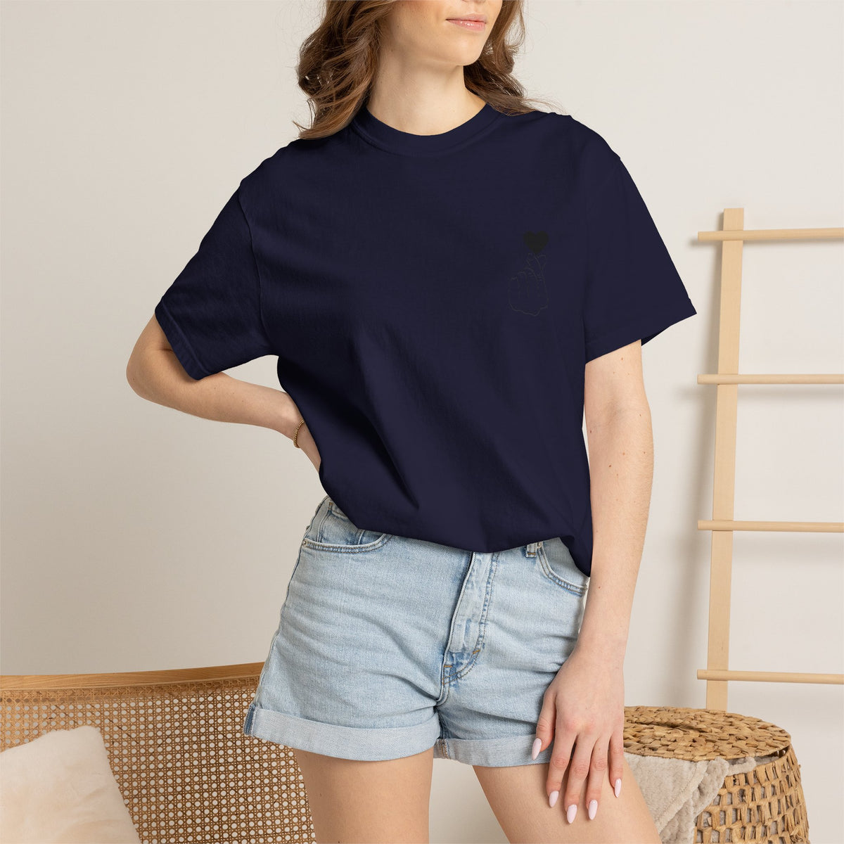 Black T-shirt with a minimal white finger heart graphic, designed by Printify, showcasing a simple and stylish graphic tee.