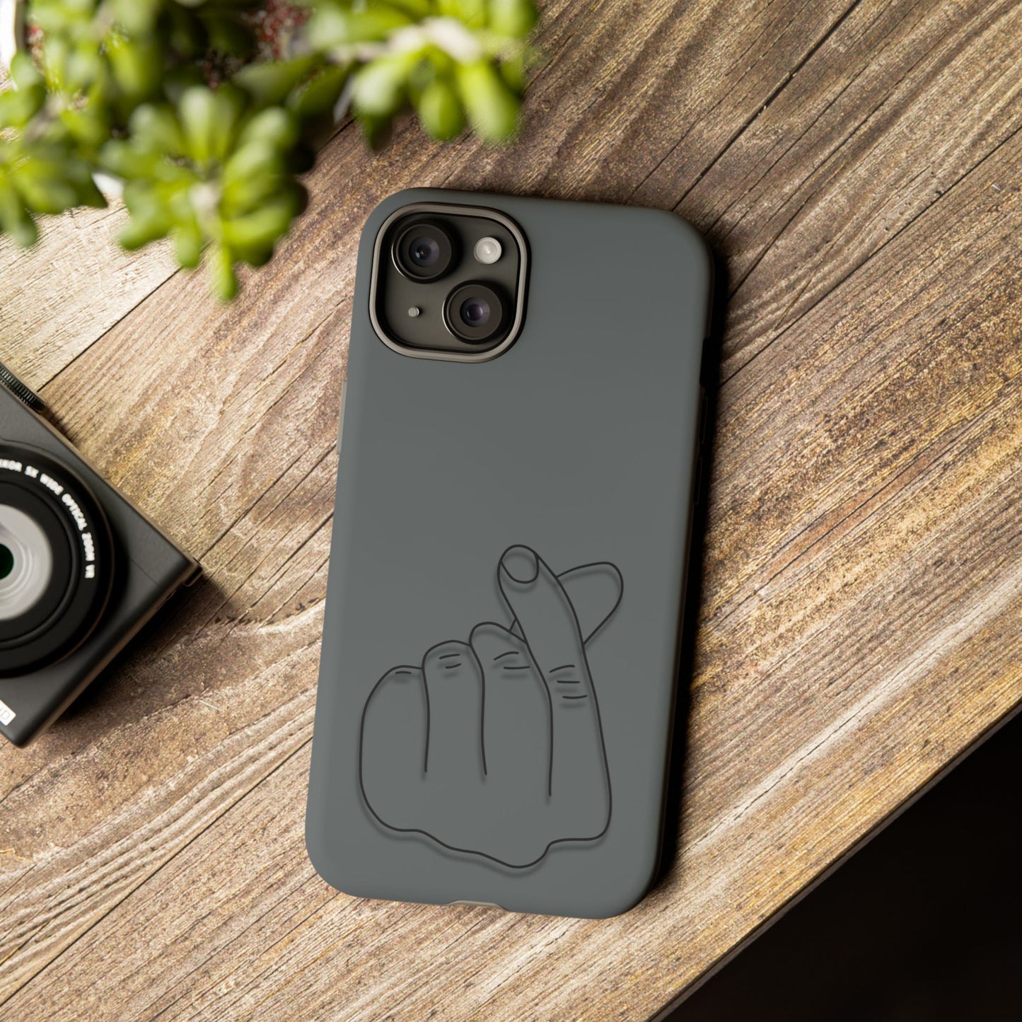 Silicone phone case with embossed Korean finger heart design, compatible with smartphones, by Printify.