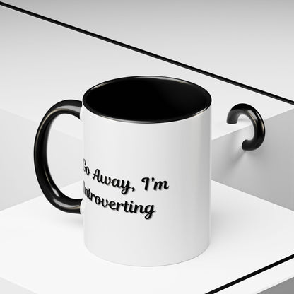 Ceramic coffee mug with "Go Away, I'm Introverting" slogan, 11 oz size, featuring a white background and black text.