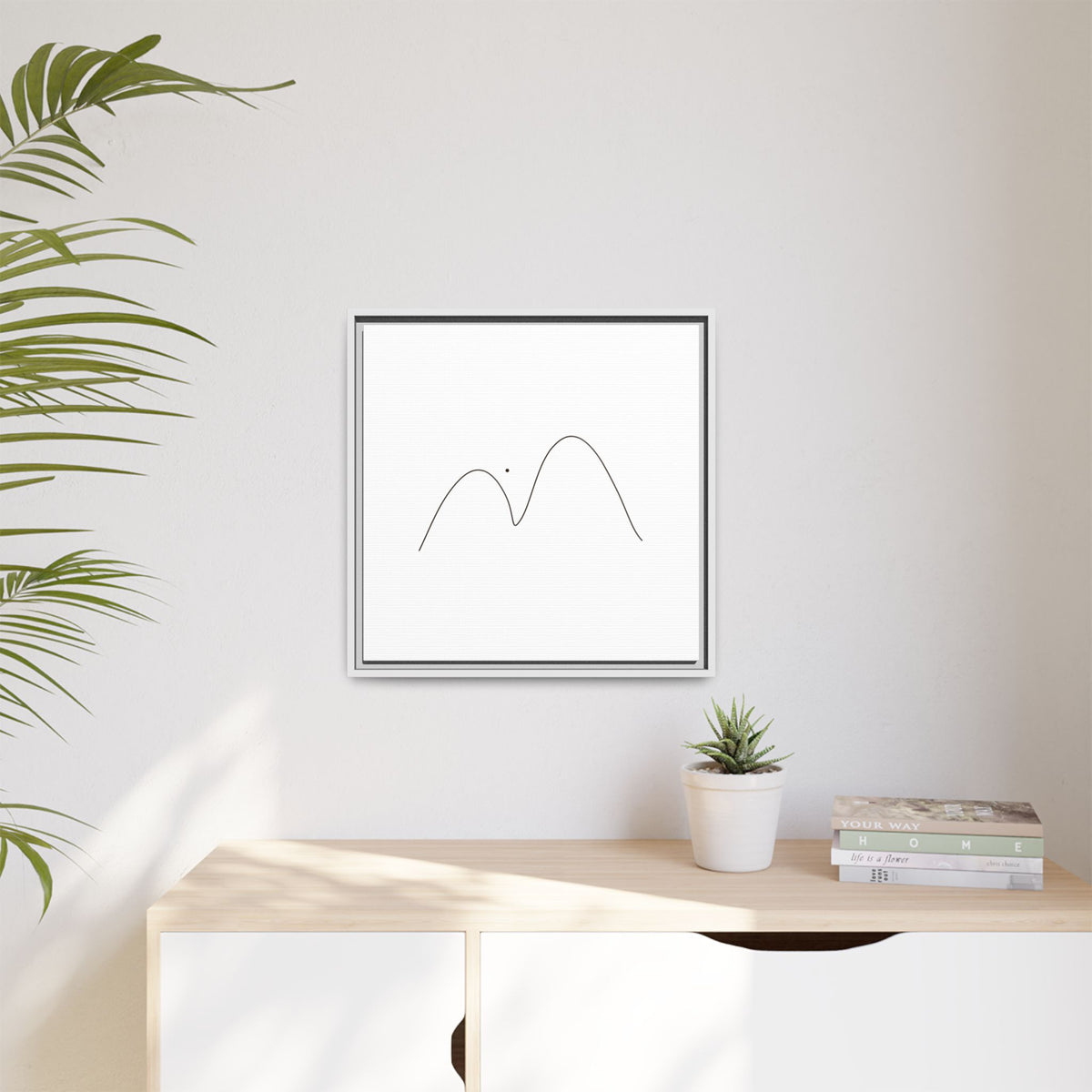 Minimalist mountain line art on framed matte canvas by Printify, showcasing a simple mountain design in black ink.