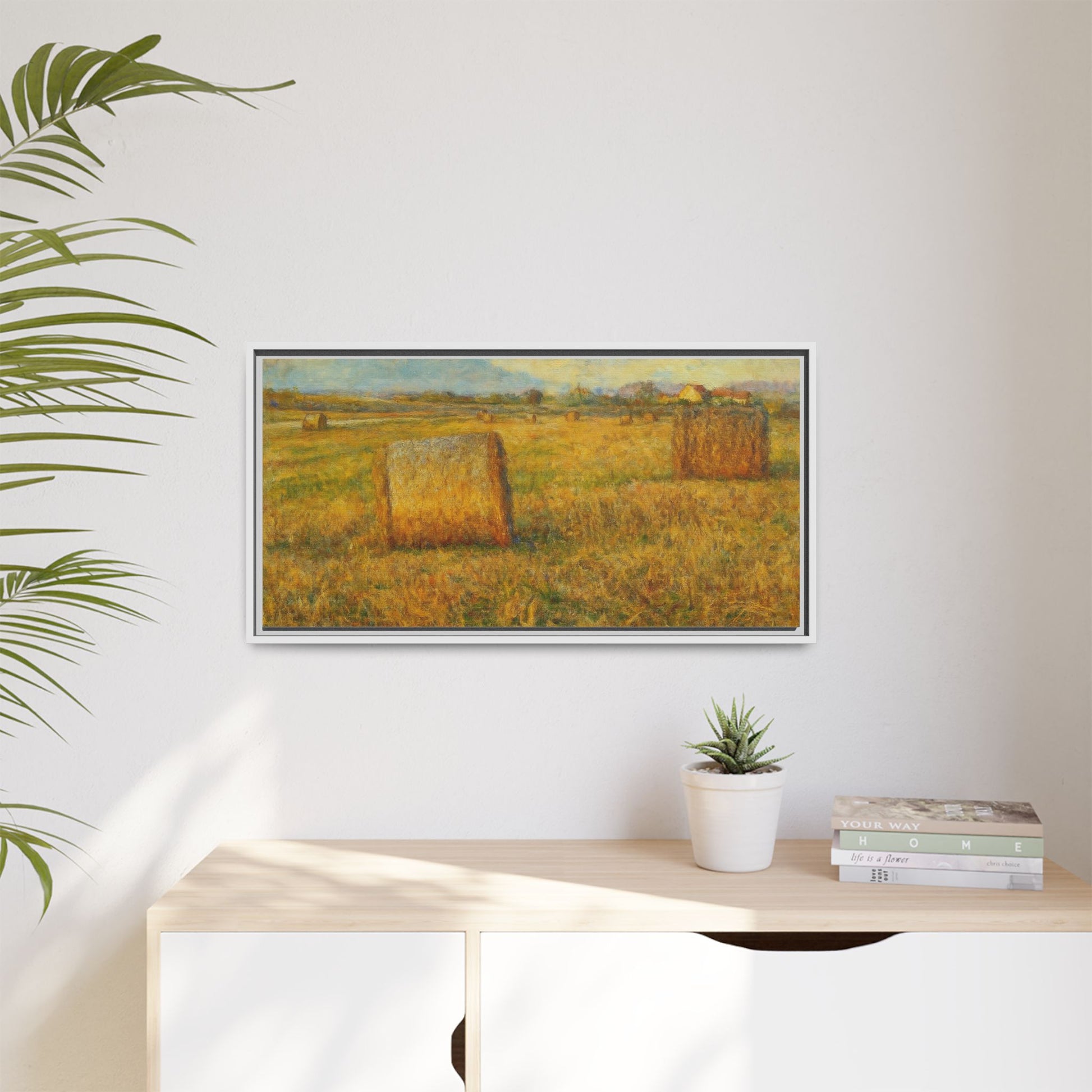 Framed matte canvas wall art featuring a rustic hayfield landscape print, showcasing vibrant colors and natural scenery.