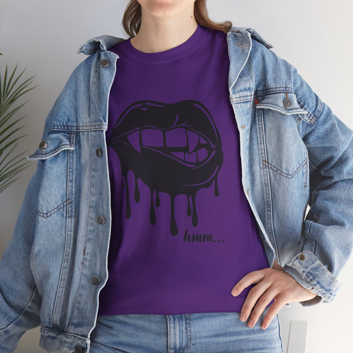 Graphic T-shirt by Printify featuring dripping lips with a "hmm..." bite design on a black fabric.