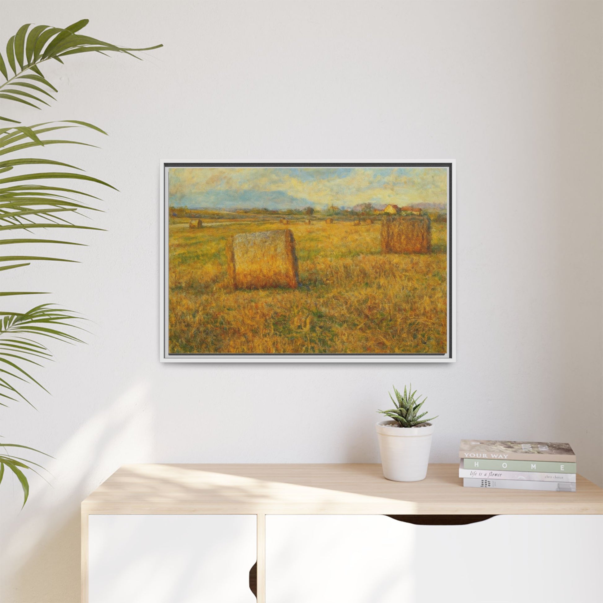 Framed matte canvas wall art featuring a rustic hayfield landscape print, showcasing a peaceful countryside scene.