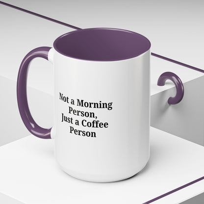 Ceramic coffee mug with "Not a Morning Person, Just a Coffee Person" quote, designed by Printify, featuring a white handle and lettering.