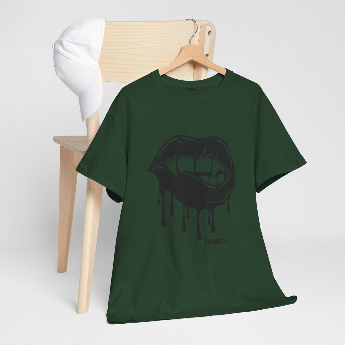 Graphic T-shirt by Printify featuring dripping lips and a "hmm..." bite design on a casual black tee.