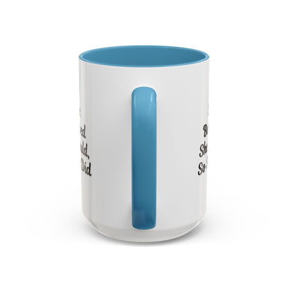 White ceramic motivational coffee mug with black text saying "She Believed She Could, So She Did" on a plain background.