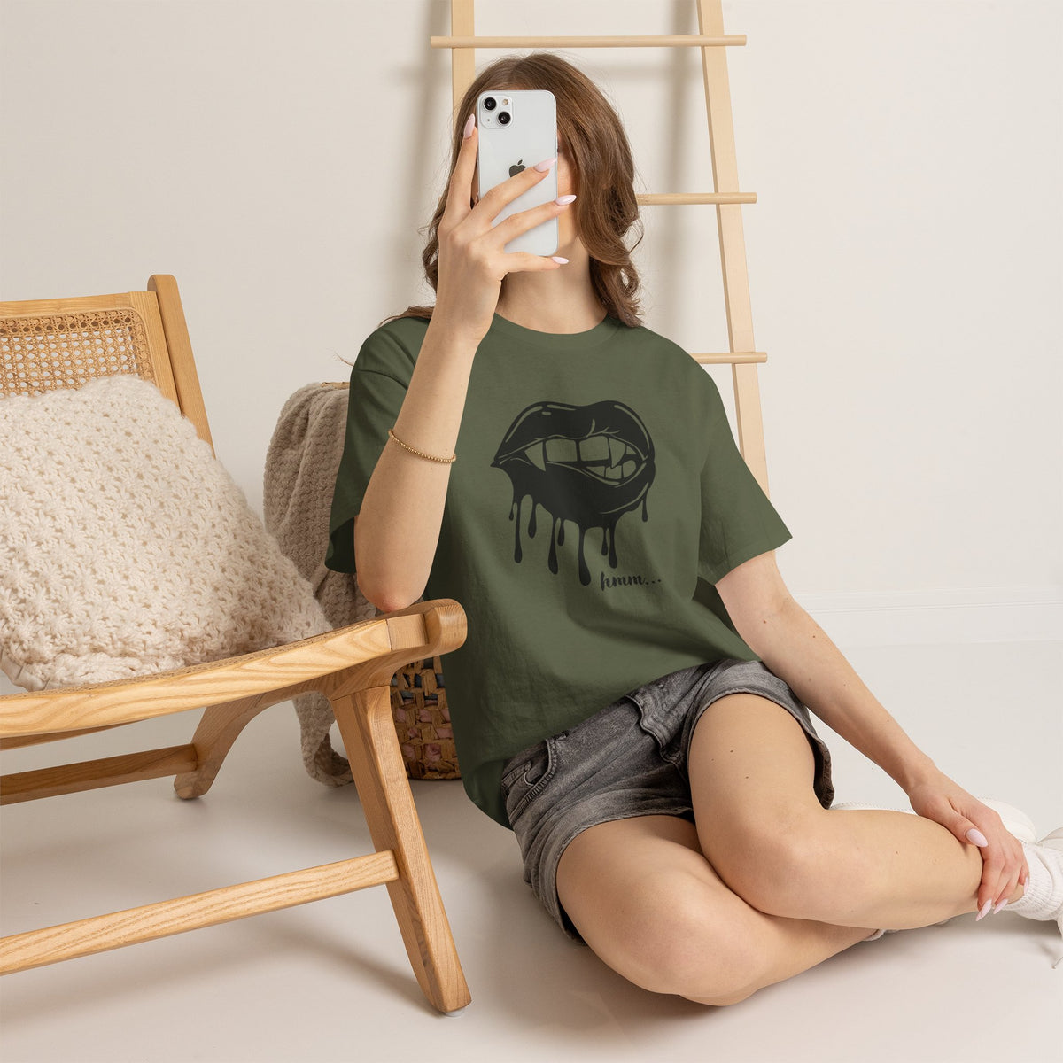 Graphic T-shirt featuring dripping lips and "hmm..." bite design, from Printify, with bold print artwork on the front.