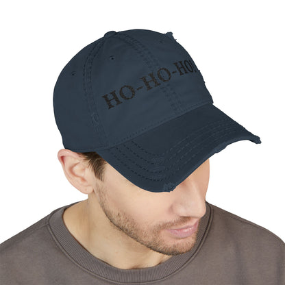 Distressed embroidered "HO-HO-HO" dad hat by Printify, navy baseball cap with festive holiday design and adjustable strap.