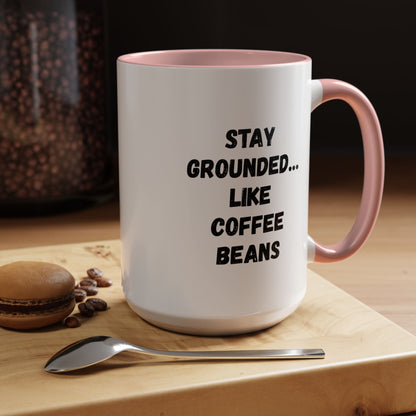 Black ceramic coffee mug with "Stay Grounded Like Coffee Beans" slogan, perfect for coffee lovers, 11oz size.
