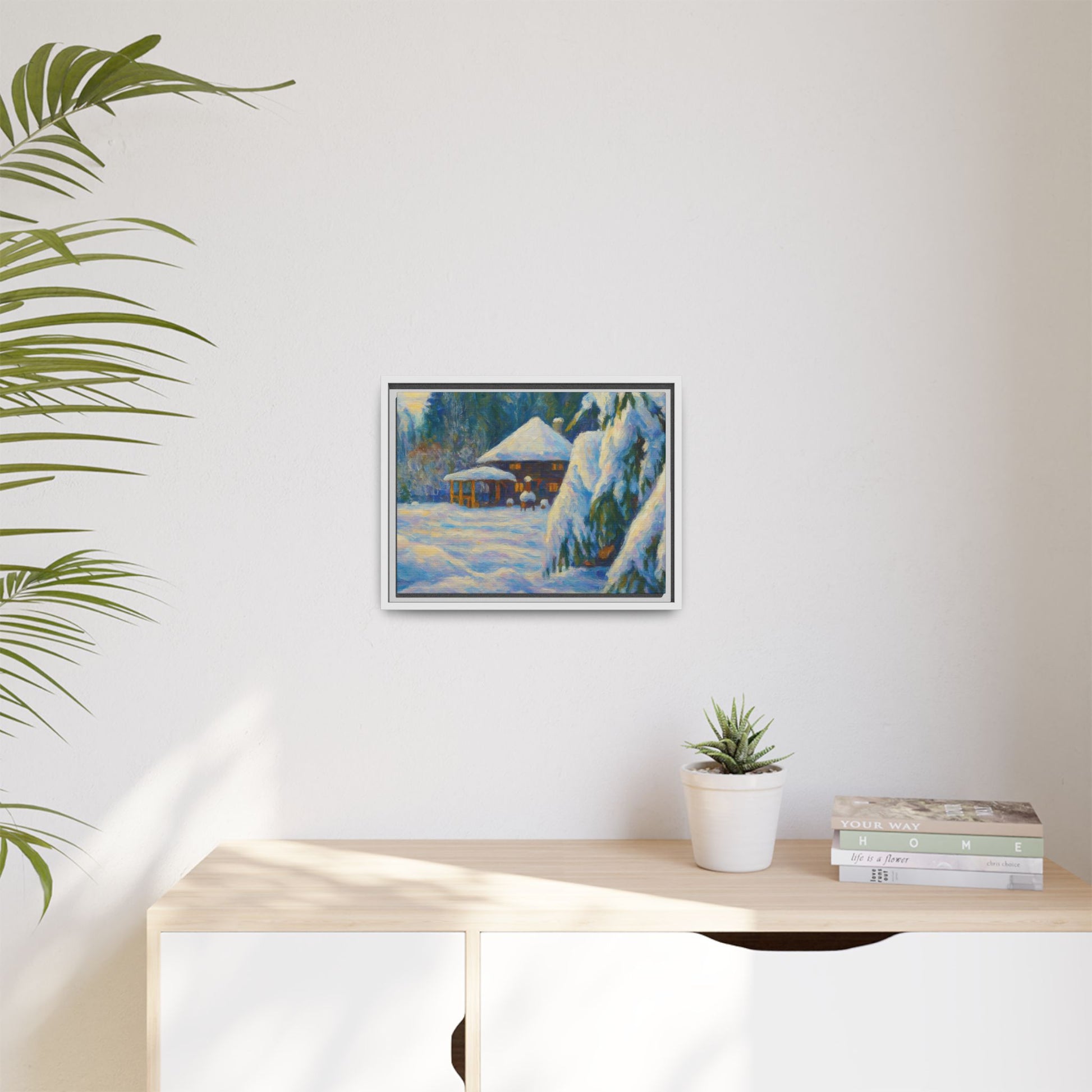 Framed matte canvas print of snowy cabin winter landscape wall art by Printify, showcasing a cozy winter scene with trees and snow.