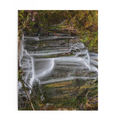 Mossy Waterfall Puzzle by Printify showing a detailed nature scene with lush greenery and cascading waterfall pieces.