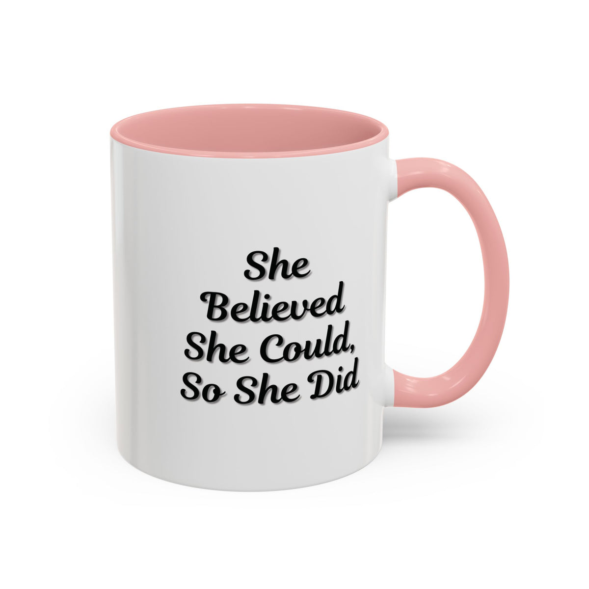 White ceramic motivational coffee mug with black text, "She Believed She Could, So She Did," by Printify.