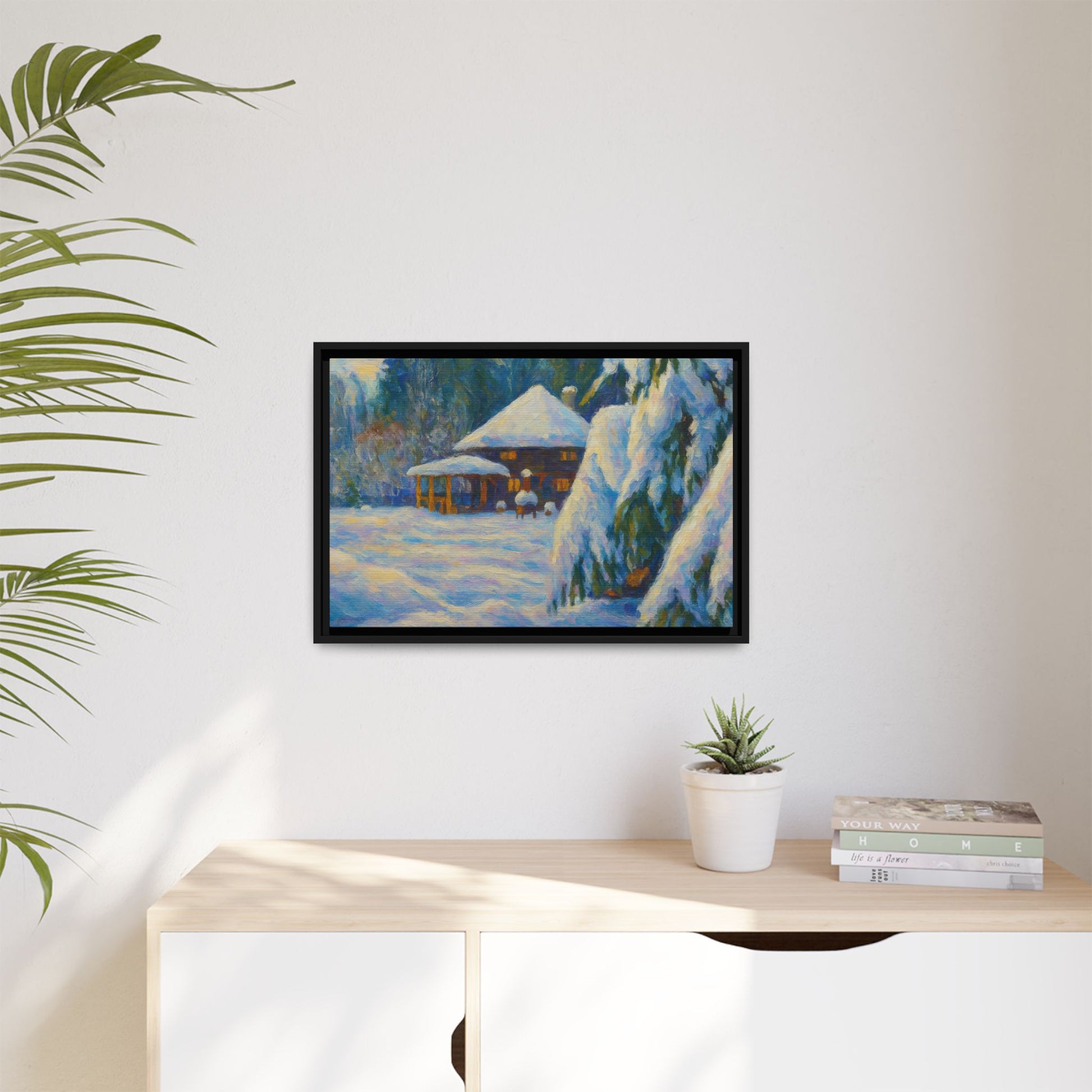 Framed matte canvas print of a snowy cabin winter landscape wall art by Printify, showcasing a cozy cabin surrounded by snow.