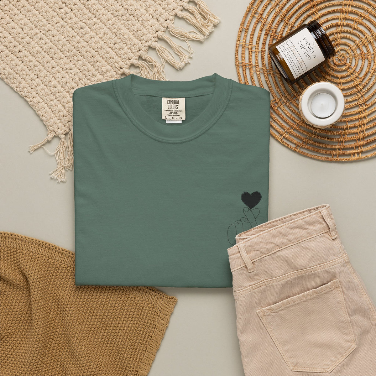 Black T-shirt featuring a minimal white finger heart graphic, ideal for casual wear and stylish fashion statements.