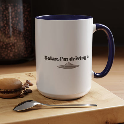 Ceramic coffee mug with "Relax, I’m Driving" UFO accent design in 11 oz size, featuring a playful space-themed print.