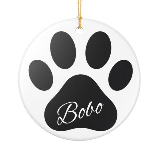 Black paw print ceramic ornament with pet's engraved name, ideal for pet memorial Christmas decoration.