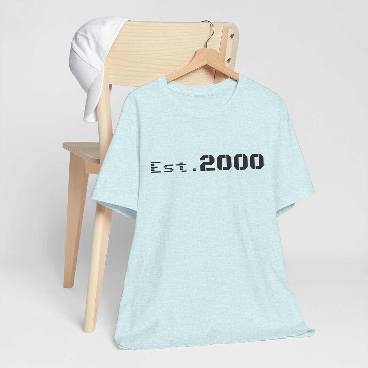 Retro pixel design T-shirt by Printify featuring "Born in 2000" text, celebrating the 2000 birth year with vibrant graphics.