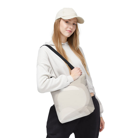 Beige tote bag with neutral abstract circle pattern, made of canvas, featuring minimal design and sturdy handles.
