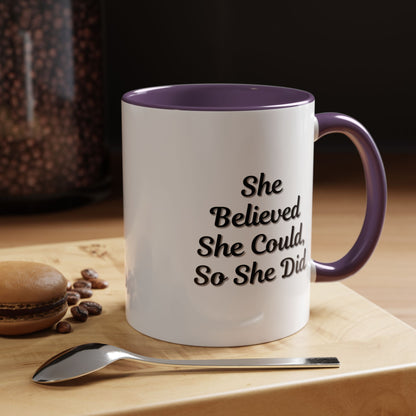 Ceramic motivational coffee mug with the phrase "She Believed She Could, So She Did" printed in black lettering.