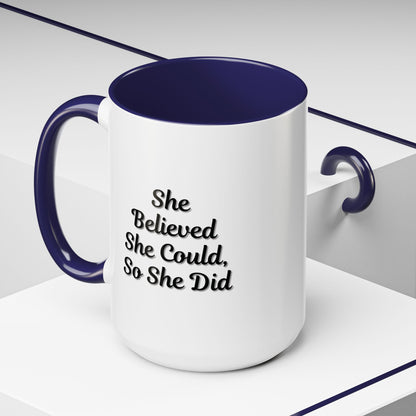 Motivational coffee mug with "She Believed She Could, So She Did" quote in black text on a white ceramic mug.