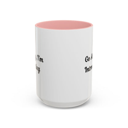 Ceramic coffee mug with "Go Away, I'm Introverting" text, 11 oz size, featuring a white exterior and black handle.