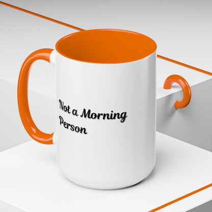 Ceramic coffee mug with "Not a Morning Person" print, 11oz or 15oz capacity, ideal for morning beverages.