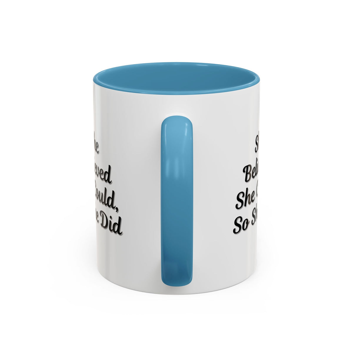 White ceramic motivational coffee mug with black text saying "She Believed She Could, So She Did" on the front.