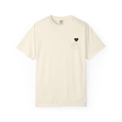 Black T-shirt with minimal finger heart graphic design by Printify, featuring a small black heart on the front.